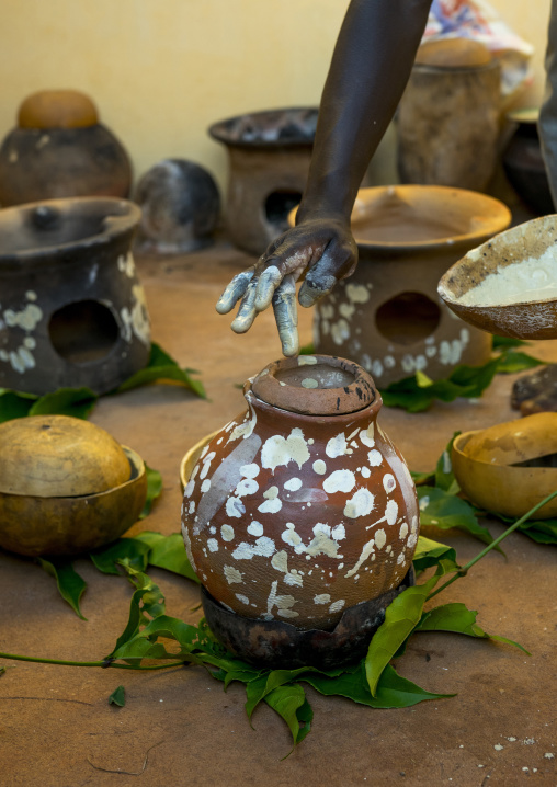 Benin, West Africa, Bonhicon, kagbanon bebe voodoo priest during a ceremony drawing white spots on a pot