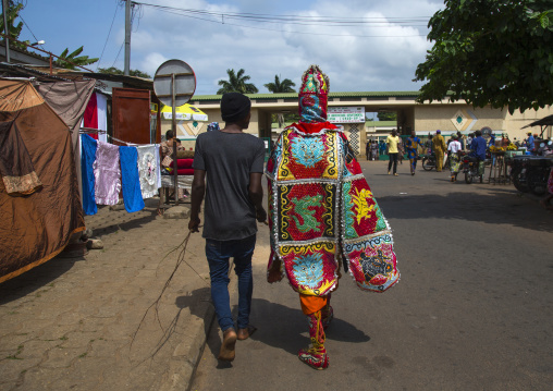 Benin, West Africa, Porto-Novo, egoun egoun spirit of the deads walking in the street with his guide to ask money to people
