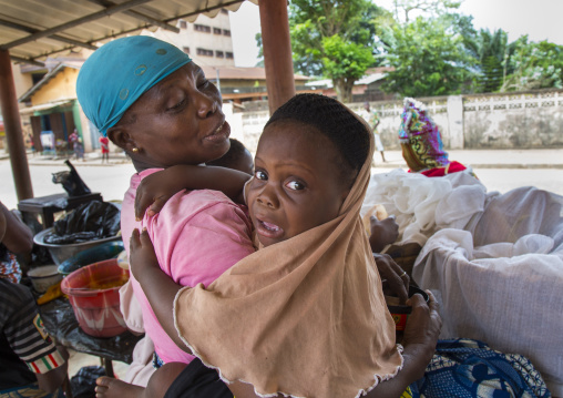 Benin, West Africa, Porto-Novo, child afraid in front of the egoun egoun spirit of the deads who asks for money in exchange of blessings
