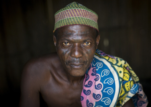 Benin, West Africa, Onigbolo Isaba, holi tribe man covered with traditional facial tattoos and scars portrait