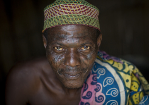 Benin, West Africa, Onigbolo Isaba, holi tribe man covered with traditional facial tattoos and scars portrait