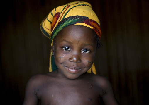 Benin, West Africa, Onigbolo Isaba, holi tribe girl with traditional facial tattoos and scars portrait