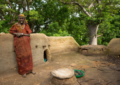 Togo, West Africa, Nadoba, woman standing on the roof of a traditional tata somba house