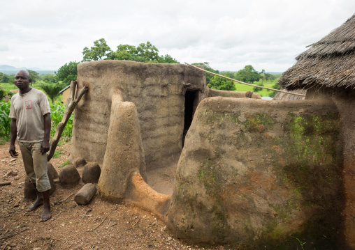 Togo, West Africa, Nadoba, man standing on the roof of a traditional tata somba house