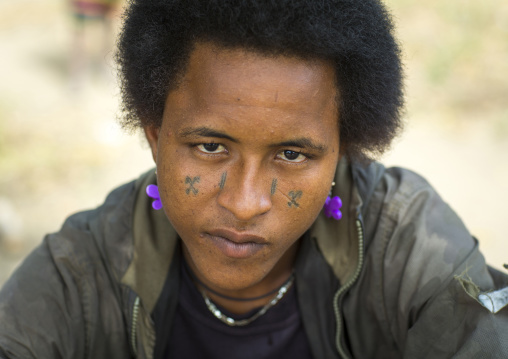 Benin, West Africa, Gossoue, peul tribe man with scars on the face and female earrings