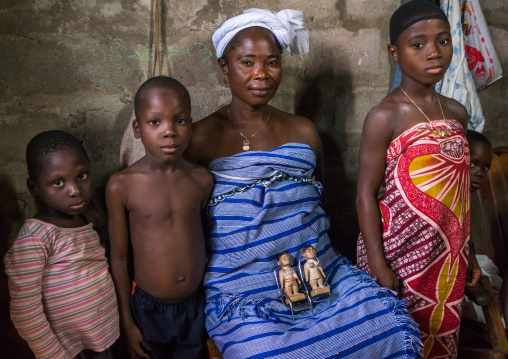 Benin, West Africa, Bopa, miss hounyoga with the carved wooden figures made to house the soul of her dead twins zinsou the boy and zinhoue the girl
