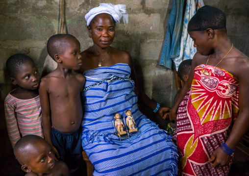 Benin, West Africa, Bopa, miss hounyoga with the carved wooden figures made to house the soul of her dead twins zinsou the boy and zinhoue the girl