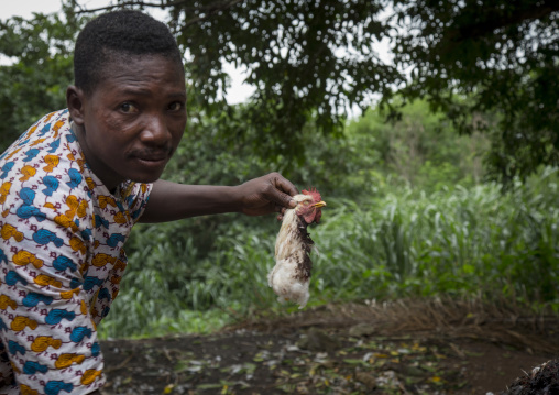Benin, West Africa, Dankoly, a voodoo priest holding a chichen cut head