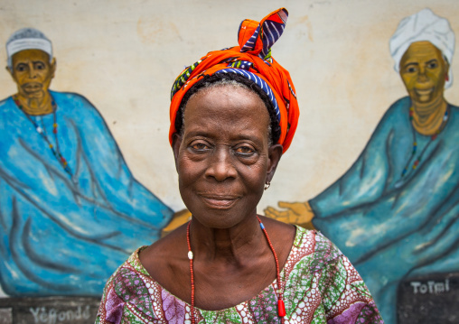 Benin, West Africa, Savalou, a priestess from the voodoo covent of the royal palace in front of a painted wall