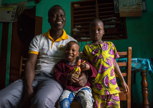 Benin, West Africa, Ouidah, eric and his sons with the carved wooden figure of their dead twin paterna