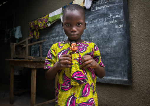 Benin, West Africa, Ouidah, edouard takes cares of the carved wooden figure made to house the soul of his dead sister paterna