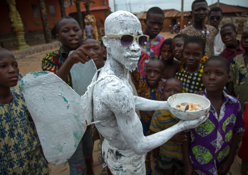 Benin, West Africa, Savalou, man disguised as an angel collecting money in the street