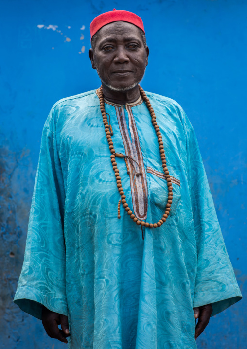 Benin, West Africa, Copargo, zachary muslim man standing in front of a blue wall