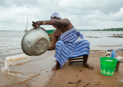 Benin, West Africa, Bopa, miss hounyoga washing the carved wooden figures made to house the soul of her dead twins