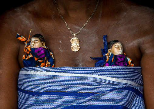 Benin, West Africa, Bopa, miss hounyoga carrying the carved wooden figures made to house the soul of her dead twins