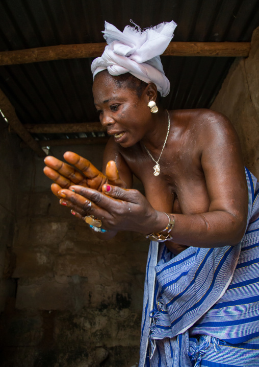 Benin, West Africa, Bopa, mrs hounyoga prays the twins spirits in the dan temple