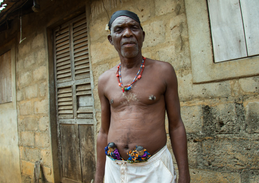 Benin, West Africa, Bopa, dah tofa carrying the carved wooden figures made to house the soul of his dead twins