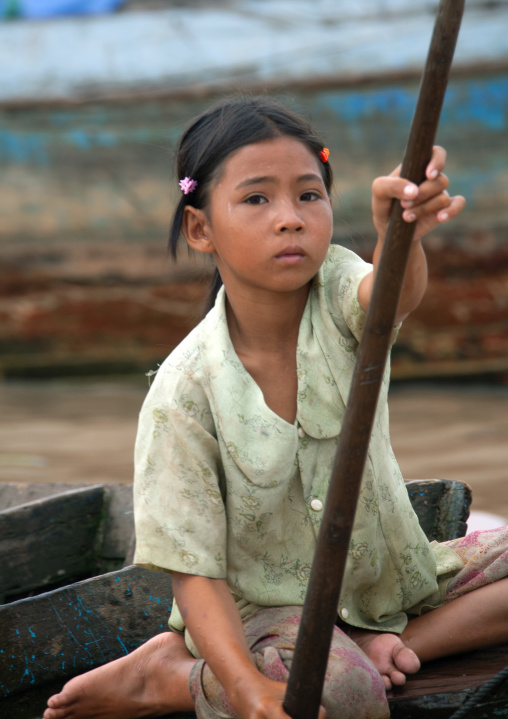 Cambodian girl on a boat in the floating village on Tonle Sap lake, Siem Reap Province, Chong Kneas, Cambodia