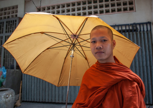 Cambodian monk walking in the street with umbrella, Phnom Penh province, Phnom Penh, Cambodia