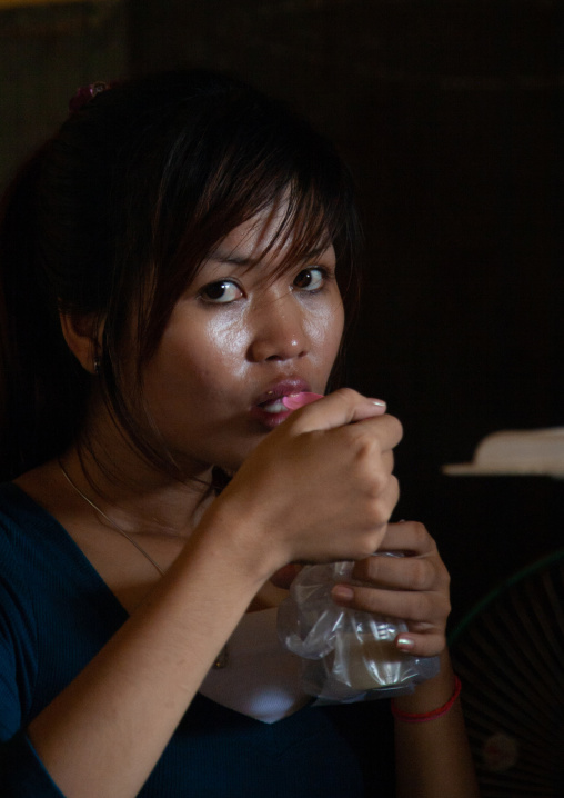 Portrait of a cambodian woman eating food, Phnom Penh province, Phnom Penh, Cambodia
