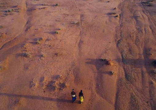 Aerial view of two women waliking in an arid area, Oromia, Yabelo, Ethiopia