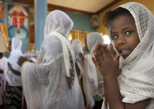 Portrait of a girl praying during an Ethiopian wedding in an orthodox church, Zway, Ethiopia