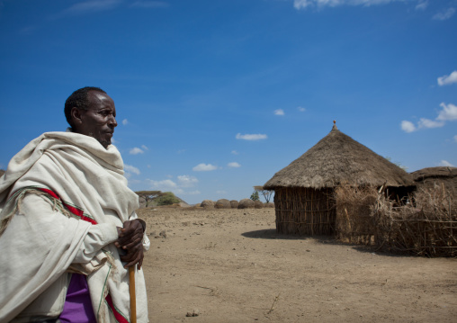 Profile Picture Of An Old Karrayyu Tribe Man Wrapped In A Traditional Cover And Standing In Front Of His Wooden House, Metahara, Ethiopia