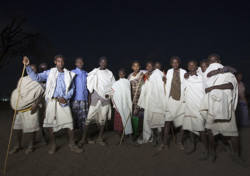 Night Shot Of A Group Of Karrayyu Tribe Men Standing Proud During Gadaaa Ceremony, Metahara, Ethiopia