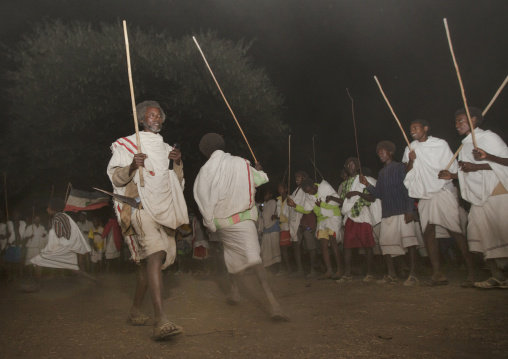 Night Shot Of Two Karrayyu Tribe Men During A Choreographed Stick Fighting Dance At Gadaaa Ceremony, Metahara, Ethiopia