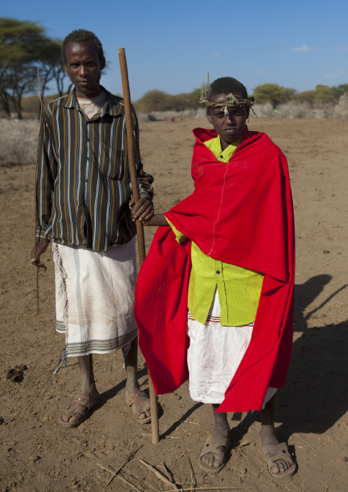 Karrayyu Tribe Kid From The Former Ruler Family In Red Wrap Around Clothes With A Headnband Made Of Branches In Gadaa Ceremony, Metehara, Ethiopia