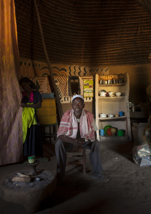 Portrait of a smiling muslim man and his wife inside their tukul, Alaba, Ethiopia