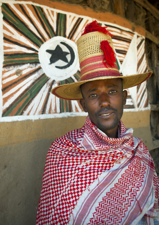 Portrait of a muslim man with tall hat inside his tukul, Alaba, Ethiopia