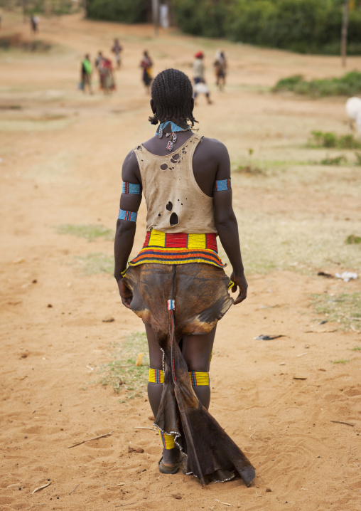 Tsemay tribe woman wearing a traditional suit at key afer market, Omo valley, Ethiopia