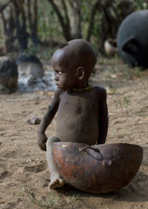 Banna Baby Boy Sitting On The Floor Near Half Calabash Ethiopia
