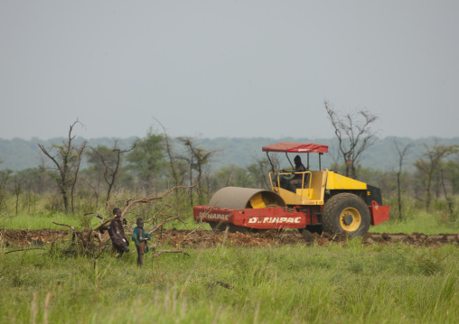 Bulldozer And Indigenous People Near Coated Road Under Construction In Mago Park Omo Valley Ethiopia