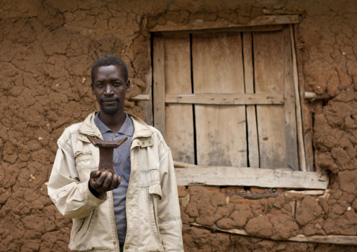 Man With Headrest In Front Of Clay House Omo Valley Ethiopia