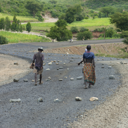 Teenage Boys Walking On Coated Road Strewed With Stones Ethiopia