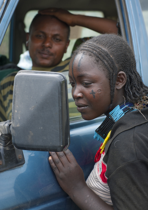 Tattooed Face Woman Looking To Herself In The Mirror Of A Car Ethiopia