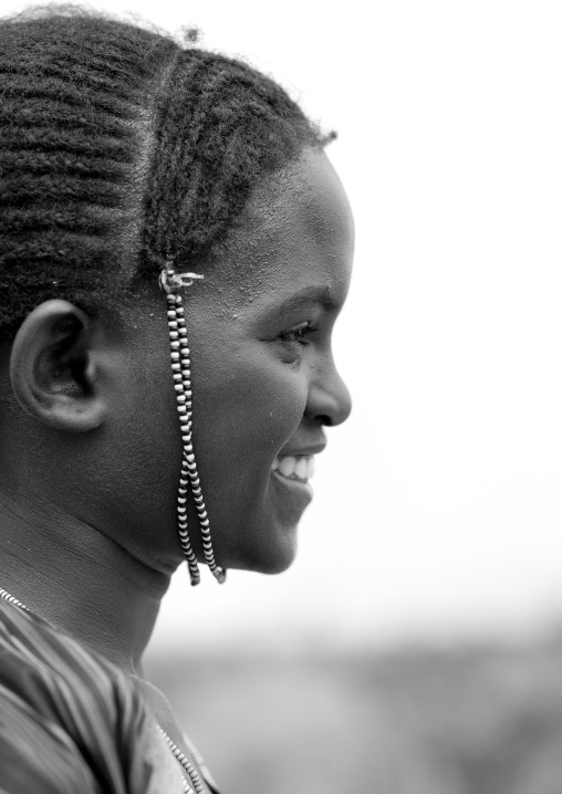 Profile young beautiful woman with braided hair and beads ornament omo valley Ethiopia