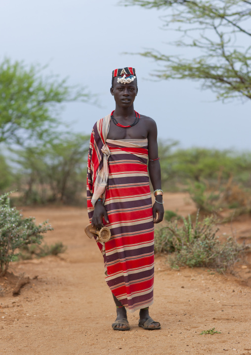 Hamer Man Dressed In Traditional Loincloth With Hat And Holding Headrest Omo Valley Ethiopia