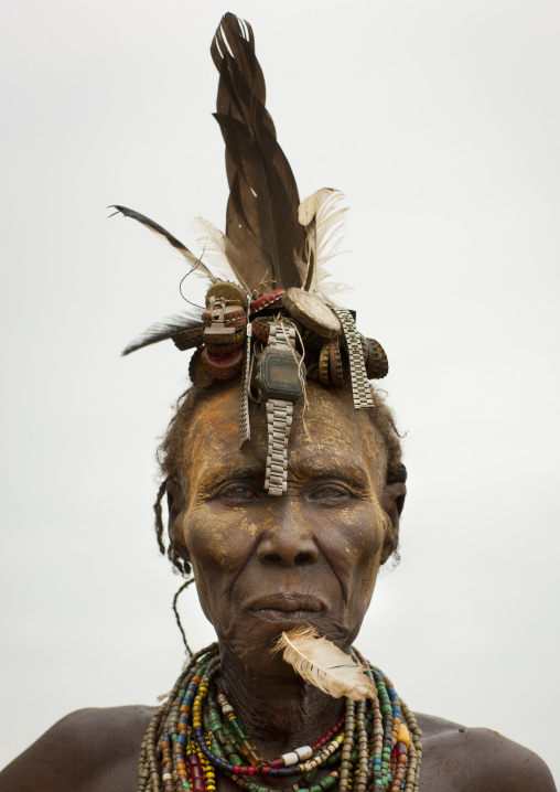 Senior Dassanech Woman Wearing Watch As Headdress And Feather In The Chin Portrait Omo Valley Ethiopia