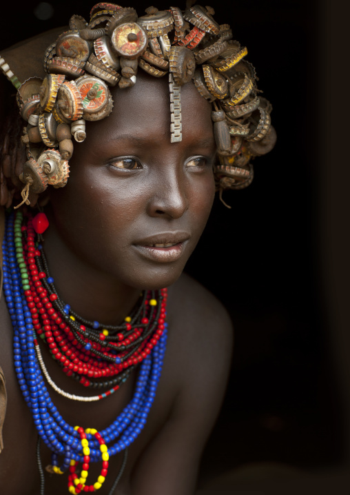 Portrait Of A Young Dassanech Cute Woman Wearing Bottle Caps Headgear And Beaded Necklaces Omo Valley Ethiopia