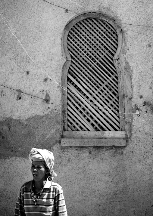Black And White Picture Of A Woman Down An Old Wooden Window In Harar, Ethiopia