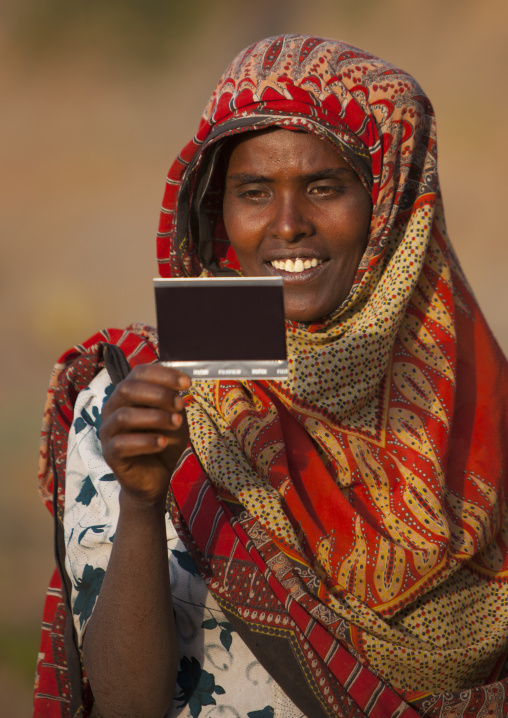 Portrait of a woman with toothy smile seing herself on picture for the first time, Dire dawa, Ethiopia