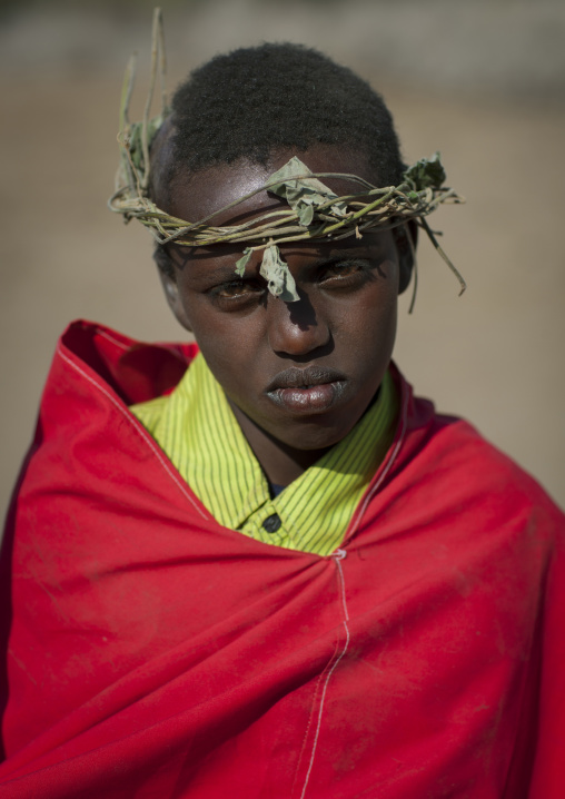 Portrait Of A Karrayyu Tribe Boy From The Former Ruling Family In Red Wrap Around Clothes And With Headband Made Out Of Branches During Gadaaa Ceremony, Metahara, Ethiopia