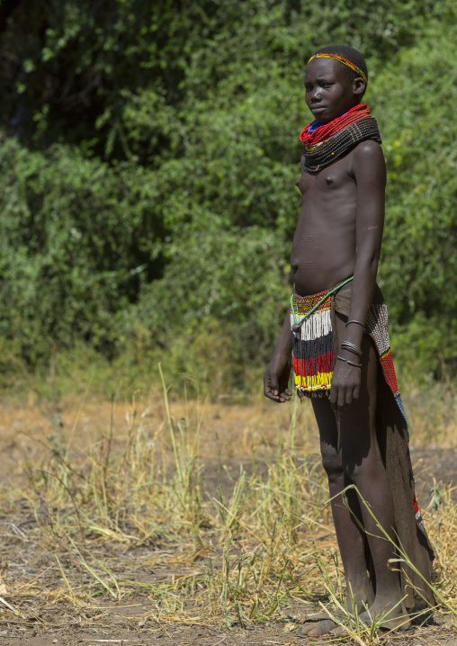 Portrait Of A Nyangatom Tribe Girl With Traditional Beaded Skirt, Omo Valley, Kangate, Ethiopia