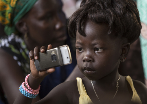 Girl Taking Pictures With Her Mobile Phone During A Catholic Sunday Church Service, Gambela, Ethiopia