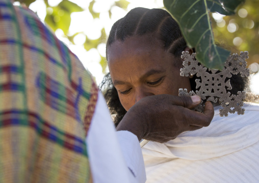 Ethiopian Orthodox Priest Blessing The Pilgrims With A Cross During The Timkat Epiphany Festival, Lalibela, Ethiopia