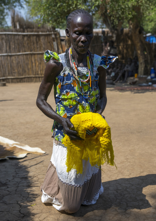 Anuak Tribe Woman Serving Food In The Tradtiional Way By Walking On Her Knees, Gambela, Ethiopia