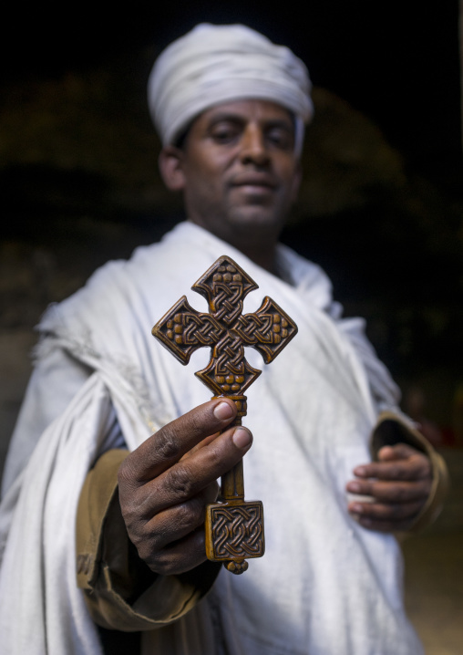 Priest Holding A Cross Inside Yemrehana Krestos Rock Church, Lalibela, Ethiopia